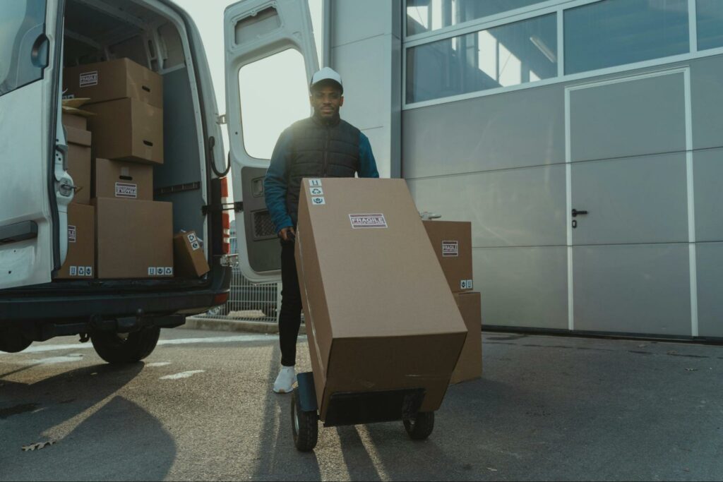 A man carrying package in a trolley