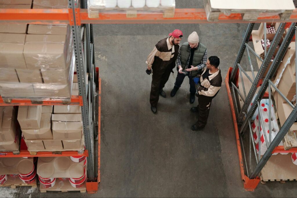 Three men in a warehouse